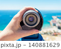 Hand Holding Tourist Viewing Telescope Overlooking Harbor and Sea 140881629