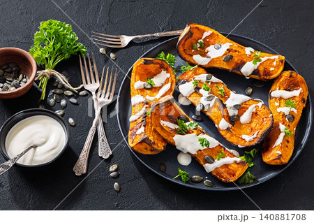 Baked butternut squash halves with yogurt sauce Baked butternut squash halves with yogurt sauce 140881708