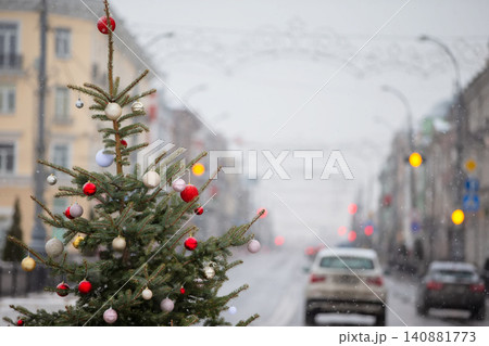 Winter street decorated with a Christmas tree on a snowy day in a vibrant city center Winter street decorated with a Christmas tree on a snowy day in a vibrant city center 140881773