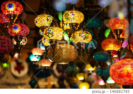 Colorful decorative lanterns hanging in a bustling market at night create a vibrant atmosphere for visitors Colorful decorative lanterns hanging in a bustling market at night create a vibrant atmosphere for visitors 140881785