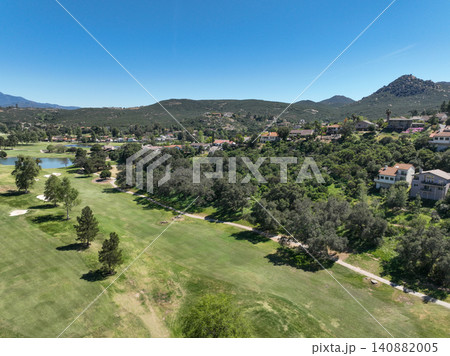 Aerial view of Ramona neighborhood with mountain, valley and golf course 140882005