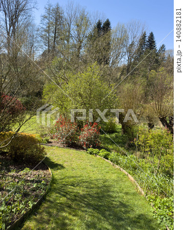 Enlgish green garden with multpiple type of trees and plants 140882181