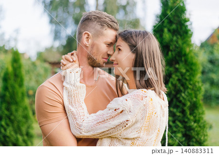 Romantic Couple Closeup Portrait In Garden With Tender Embrace Romantic Couple Closeup Portrait In Garden With Tender Embrace 140883311