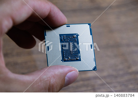 The processor is a desktop computer in hand. Inspect the CPU contacts before installing The processor is a desktop computer in hand. Inspect the CPU contacts before installing 140883784
