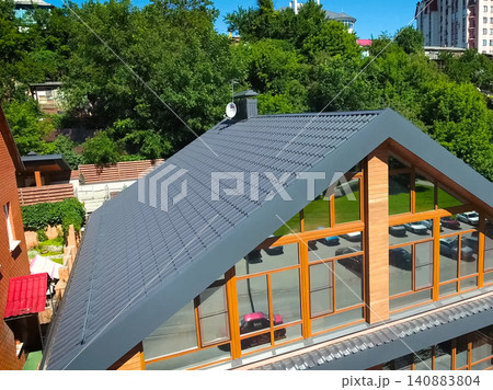 Corrugated metal roof and metal roofing. Modern roof made of metal. Corrugated metal roof and metal roofing. Modern roof made of metal. 140883804