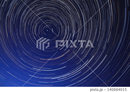 Long exposure starry sky, twisted tracks of stars. Long exposure starry sky, twisted tracks of stars. 140884015