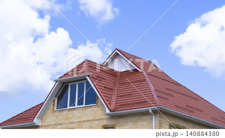 The house with plastic windows and a roof of corrugated sheet 140884380