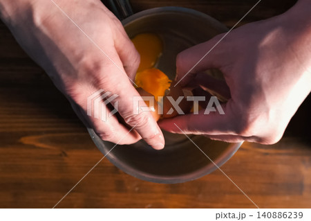 Breaking eggs in pot, raw eggs for beating. Breaking eggs in pot, raw eggs for beating. 140886239