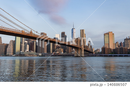 Urban architecture of New York city view. Brooklyn bridge of New York city. Brooklyn landmark. Manhattan cityscape with skyscraper architecture. Brooklyn bridge to Manhattan Urban architecture of New York city view. Brooklyn bridge of New York city. Brooklyn landmark. Manhattan cityscape with skyscraper architecture. Brooklyn bridge to Manhattan 140886507