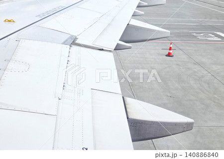 Airplane Wing View at Airport Runway for Travel and Aviation Design Airplane Wing View at Airport Runway for Travel and Aviation Design 140886840