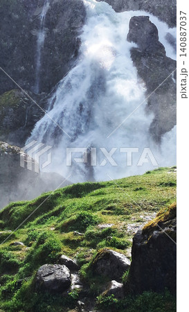Kleivafossen is one of Norway's most iconic waterfalls, on the way to the Briksdalsbreen glacier Kleivafossen is one of Norway's most iconic waterfalls, on the way to the Briksdalsbreen glacier 140887037