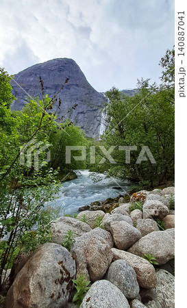 Kleivafossen is one of Norway's most iconic waterfalls, on the way to the Briksdalsbreen glacier Kleivafossen is one of Norway's most iconic waterfalls, on the way to the Briksdalsbreen glacier 140887041