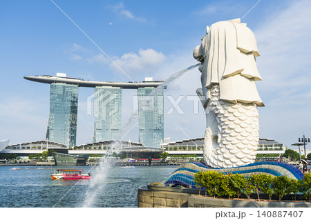 Low-angle view of the Merlion with the background of Marina Bay Sands buildings in Singapore. Merlion is the official mascot of Singapore. Low-angle view of the Merlion with the background of Marina Bay Sands buildings in Singapore. Merlion is the official mascot of Singapore. 140887407