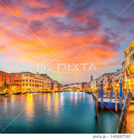 Gorgeous sunset and evening cityscape of Venice with famous Canal Grande and Rialto Bridge. 140887592