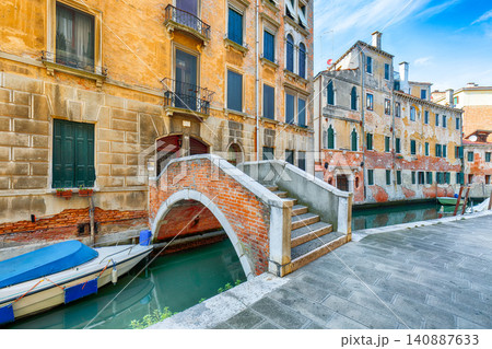 Amazing cityscape of Venice with narrow canals, boats and gondolas and bridges with traditional buildings. Amazing cityscape of Venice with narrow canals, boats and gondolas and bridges with traditional buildings. 140887633