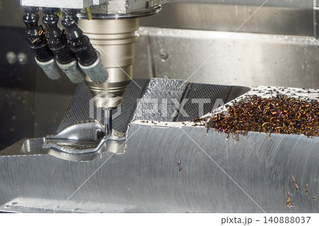 High-precision CNC milling machine performing a rough cutting process on mold parts with a ball nose end mill tool. High-precision CNC milling machine performing a rough cutting process on mold parts with a ball nose end mill tool. 140888037