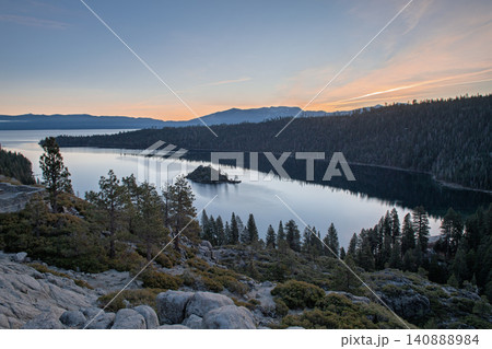 Sierra nevada california lake sunset forest mountain scenic landscape calm water with island among granite rock and pine woodland 140888984