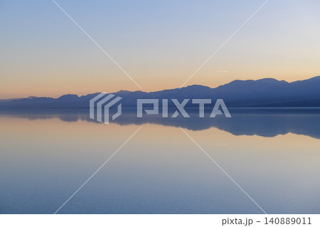 Sierra nevada california lake mountain reflection sunset sky water serene landscape with calm horizon and blue twilight glow Sierra nevada california lake mountain reflection sunset sky water serene landscape with calm horizon and blue twilight glow 140889011