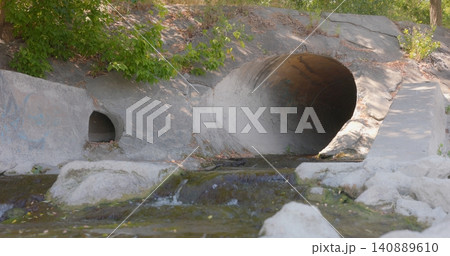 Large round sewage outlet contributing to coastal pollution Large round sewage outlet contributing to coastal pollution 140889610