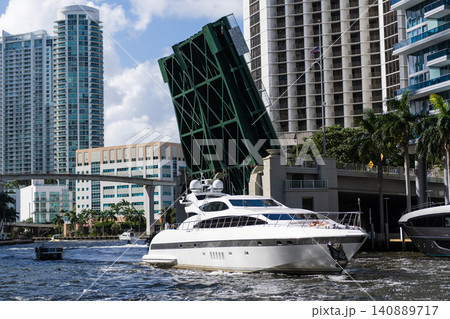 Boating and yachting charter. Luxury lifestyle. Vacation on summer. Yacht at sea. Sea vacation on summer. Luxury boat motor yacht in marina. Luxury yacht at Biscayne bay with drawbridge 140889717