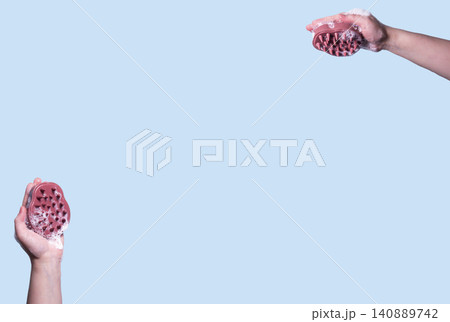 Pink hair brush for scalp massage against blue background. Mock up Pink hair brush for scalp massage against blue background. Mock up 140889742
