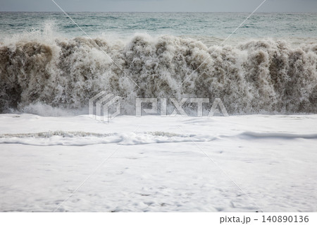 Large ocean wave breaking into white foam Large ocean wave breaking into white foam 140890136