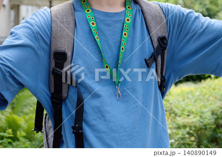 Person wearing sunflower lanyard for hidden disabilities Person wearing sunflower lanyard for hidden disabilities 140890149