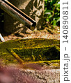 A drop of water falling into a tsukubai (a squat basin in a Japanese garden). 140890811