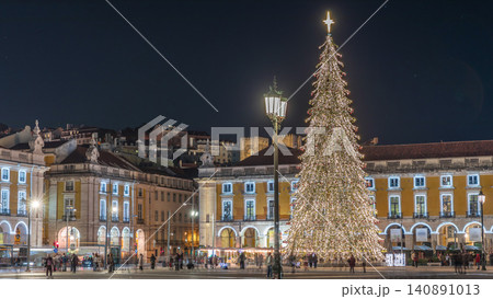 Commerce Square in Lisbon illuminated at Christmas hyperlapse, with a towering tree and crowds celebrating at night. Portugal 140891013