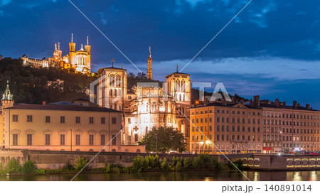 Timelapse of Saint John the Baptist Cathedral and Basilica of Notre-Dame de Fourviere in Lyon, from day to night. France 140891014