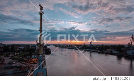 Shipyard with historical cranes in the industrial part on a riverside during sunrise aerial timelapse Shipyard with historical cranes in the industrial part on a riverside during sunrise aerial timelapse 140891205