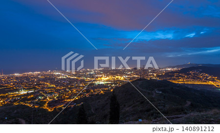 Barcelona and Badalona skyline with roofs of houses and sea on the horizon day to night timelapse Barcelona and Badalona skyline with roofs of houses and sea on the horizon day to night timelapse 140891212