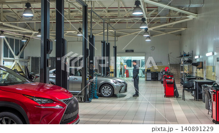 Cars moves on lifts in modern service station and men repair cars timelapse. Cars moves on lifts in modern service station and men repair cars timelapse. 140891229