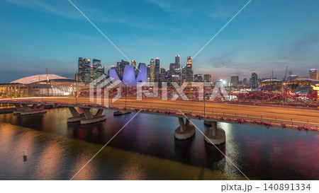 Aerial view over Helix Bridge and Bayfront Avenue with traffic day to night timelapse at Marina Bay, Singapore Aerial view over Helix Bridge and Bayfront Avenue with traffic day to night timelapse at Marina Bay, Singapore 140891334