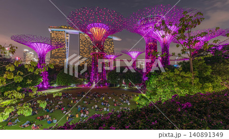 Futuristic aerial view of amazing illumination at Garden by the Bay day to night timelapse in Singapore. Futuristic aerial view of amazing illumination at Garden by the Bay day to night timelapse in Singapore. 140891349
