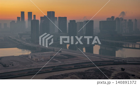 Abu Dhabi city skyline with skyscrapers before sunrise from above night to day timelapse Abu Dhabi city skyline with skyscrapers before sunrise from above night to day timelapse 140891372
