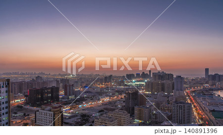 Cityscape of Ajman from rooftop day to night timelapse after sunset. Cityscape of Ajman from rooftop day to night timelapse after sunset. 140891396