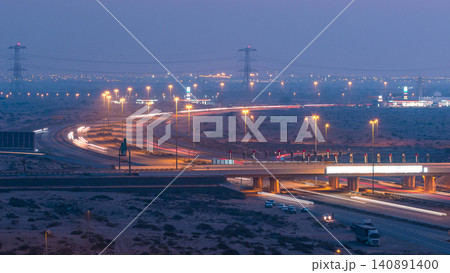 Highway roads with traffic day to night timelapse in a big city from Ajman to Dubai before sunset. Transportation concept. Highway roads with traffic day to night timelapse in a big city from Ajman to Dubai before sunset. Transportation concept. 140891400