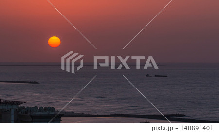 Sunset in Ajman aerial view from rooftop timelapse. United Arab Emirates. Sunset in Ajman aerial view from rooftop timelapse. United Arab Emirates. 140891401