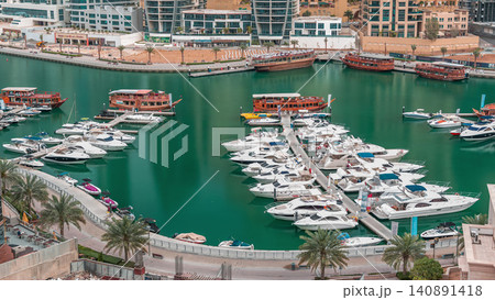 Luxury yachts parked on the pier in Dubai Marina bay with city aerial view timelapse Luxury yachts parked on the pier in Dubai Marina bay with city aerial view timelapse 140891418