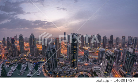 Aerial top view of Dubai Marina night to day timelapse. Modern towers and traffic on the road Aerial top view of Dubai Marina night to day timelapse. Modern towers and traffic on the road 140891457