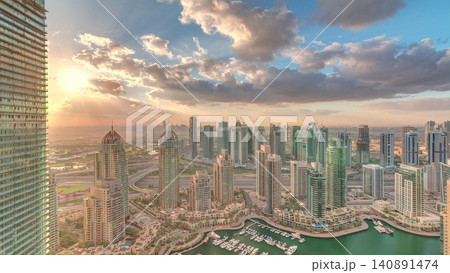 Dubai Marina skyscrapers and jumeirah lake towers view from the top aerial timelapse in the United Arab Emirates. Dubai Marina skyscrapers and jumeirah lake towers view from the top aerial timelapse in the United Arab Emirates. 140891474