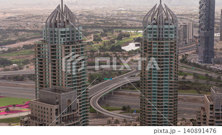 Dubai Marina skyscrapers and jumeirah lake towers sunrise view from the top aerial timelapse in the United Arab Emirates. Dubai Marina skyscrapers and jumeirah lake towers sunrise view from the top aerial timelapse in the United Arab Emirates. 140891476