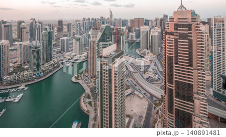 Dubai Marina skyscrapers and jumeirah lake towers view from the top aerial night to day timelapse in the United Arab Emirates. Dubai Marina skyscrapers and jumeirah lake towers view from the top aerial night to day timelapse in the United Arab Emirates. 140891481