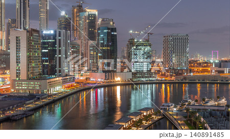 Dubai skyscrapers after sunset near river aerial day to night timelapse Dubai skyscrapers after sunset near river aerial day to night timelapse 140891485