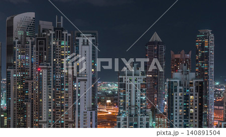 Modern residential and office complex with many towers aerial night timelapse at Business Bay, Dubai, UAE. Modern residential and office complex with many towers aerial night timelapse at Business Bay, Dubai, UAE. 140891504