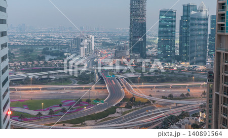 Aerial view of a road intersection in a big city day to night timelapse. 140891564