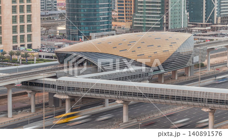 Aerial view of Jumeirah lakes towers skyscrapers night to day timelapse with traffic on sheikh zayed road. Aerial view of Jumeirah lakes towers skyscrapers night to day timelapse with traffic on sheikh zayed road. 140891576