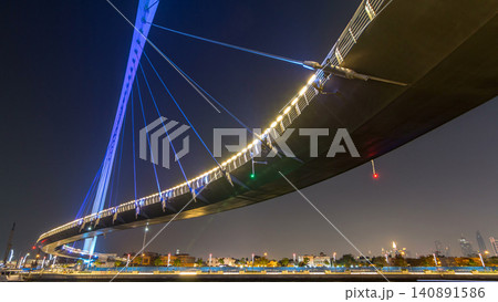 Futuristic Pedestrian Bridge over the Dubai Water Canal Illuminated at Night timelapse hyperlapse, UAE. Futuristic Pedestrian Bridge over the Dubai Water Canal Illuminated at Night timelapse hyperlapse, UAE. 140891586