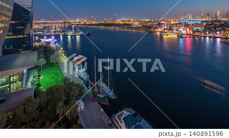 Dubai creek landscape day to night timelapse with boats and ship near waterfront Dubai creek landscape day to night timelapse with boats and ship near waterfront 140891596